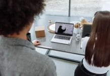 Dwoje współpracowników podczas spotkania online przy laptopie